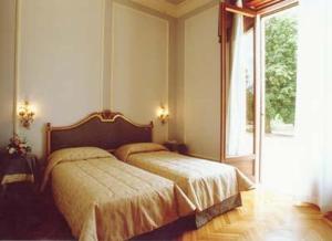 Postel nebo postele na pokoji v ubytování Park Hotel Villa Potenziani