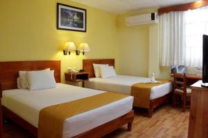 Postel nebo postele na pokoji v ubytování Hotel Madan Cárdenas