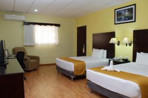 Postel nebo postele na pokoji v ubytování Hotel Madan Cárdenas