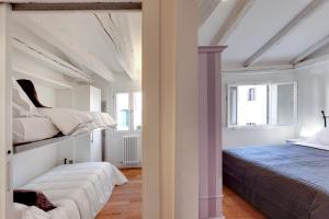 Posteľ alebo postele v izbe v ubytovaní San Marco Prestige - S. Zaccaria
