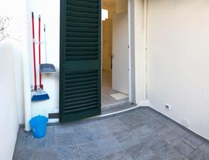 a green door in a room with a hallway at Florence Dalmazia Fast Check In on line in Florence +48 photos