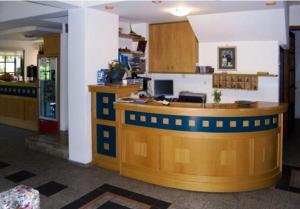 a restaurant with a counter in a room at Rea Hotel in Palaiochora