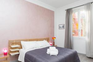a bedroom with a large bed and a window at Foresteria Boccadasse in Genoa