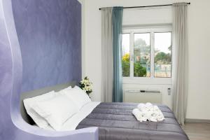 a bedroom with a bed with towels on it at Foresteria Boccadasse in Genoa