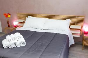 a bedroom with a large bed with towels on it at Foresteria Boccadasse in Genoa