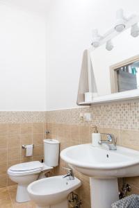 a bathroom with a sink and a toilet and a mirror at Foresteria Boccadasse in Genoa