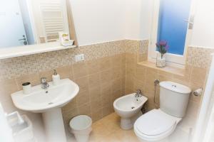a bathroom with a white toilet and a sink at Foresteria Boccadasse in Genoa