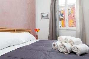 a bedroom with a bed with towels on it at Foresteria Boccadasse in Genoa