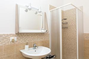 a bathroom with a sink and a mirror at Foresteria Boccadasse in Genoa