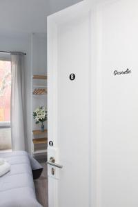 a door to a bedroom with a bed and a window at Foresteria Boccadasse in Genoa