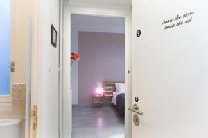 a door leading to a bedroom with a bed at Foresteria Boccadasse in Genoa