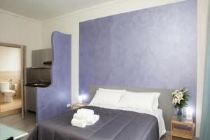 a bedroom with a bed with towels on it at Foresteria Boccadasse in Genoa
