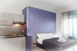 a bedroom with a bed and a purple wall at Foresteria Boccadasse in Genoa