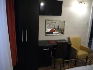 a room with a desk and a chair and a mirror at B&B Central Palace Heritage in Split