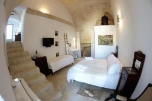 a bedroom with a staircase and a bed in a room at Albergo Diffuso Il Casale in Ginosa