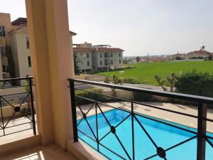 a balcony with a view of a swimming pool at Mazotos Panoramic Village in Mazotos
