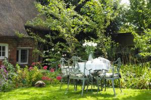 a table and chairs in the yard of a house at Nightingale Cottage Bed and Breakfast in Chichester