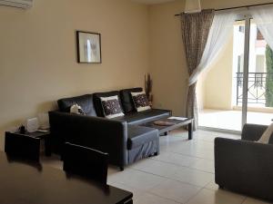 a living room with a couch and a table at Mazotos Panoramic Village in Mazotos