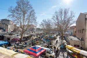 a busy city street with a market with tents at Adriatic Hostel - Youth Only in Split