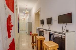 a living room with a tv and a table at Adriatic Hostel - Youth Only in Split
