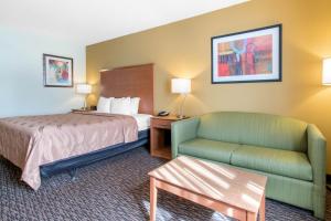 a hotel room with a bed and a couch at Clarion Hotel & Suites University-Shippensburg in Shippensburg