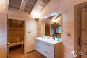 a bathroom with a sink and a mirror at Le Domaine des Fleurs - Chalet La Reine des Prés in Gérardmer +32 photos