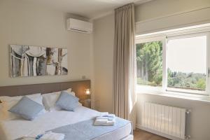 a bedroom with a bed and a large window at I Segreti della Valle in Agrigento