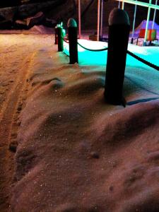 a row of poles in the snow at night at Abyrvalg Hotel in Issad