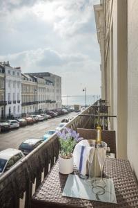 a table on a balcony with a view of a street at Portland Place in Brighton & Hove