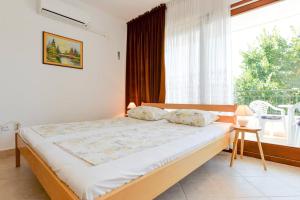 una camera da letto con un letto e una grande finestra di Rooms & Apartment Hegic a Zara (Zadar)