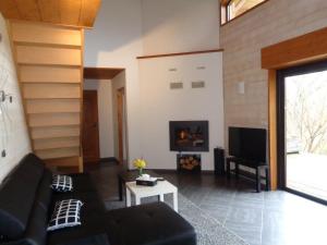a living room with a couch and a fireplace at Le Barail 31 in Couret