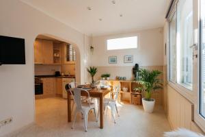 a kitchen and dining room with a table and chairs at Sitges Holiday Apartment in Sitges