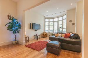 a living room with a couch and a tv at Elm Lodge in Plymouth