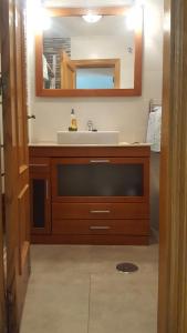 a bathroom with a sink and a mirror at Caciris in Cáceres