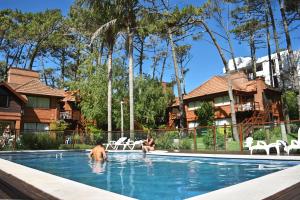 a person and a dog in a swimming pool at La Posta de Cariló in Carilo