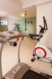 a gym with a treadmill and a simulator at Eland Dream Villas in Kalamaki