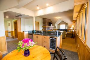 a kitchen with a table with a vase of flowers on it at Trapp Family Lodge in Stowe