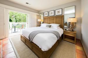 a bedroom with a bed and a large window at El Dorado Hotel in Sonoma