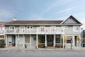 a woman standing in front of a white building at El Dorado Hotel in Sonoma