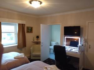 a hotel room with a bed and a desk at Dalgair House Hotel in Callander