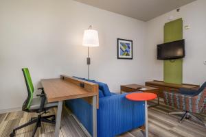 a living room with a blue couch and a table at Holiday Inn Express Phoenix-Airport/University Drive, an IHG Hotel in Phoenix