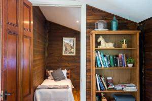 a room with a bed and a book shelf at Chum Creek Hut in Chum Creek