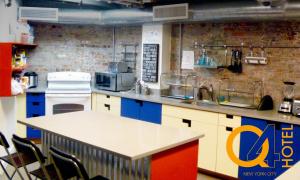 a kitchen with a counter and a counter top at Q4 Hotel and Hostel in Queens