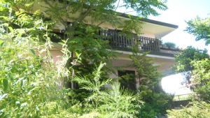 a house with a balcony on the side of it at Il Nido del Pettirosso in Borgomanero