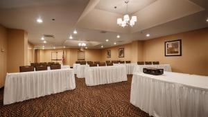 a conference room with white tables and chairs at Best Western Palm Court Inn in Modesto +17 photos