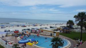 a group of people at a pool at the beach at Driftwood Beach Motel in Ormond Beach