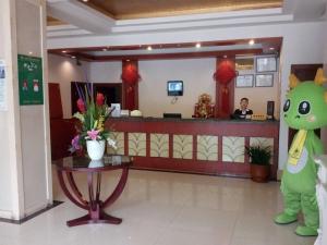 a green monster standing in front of a waiting room at GreenTree Inn Anhui Huainan Liulizhan Express Hotel in Huainan