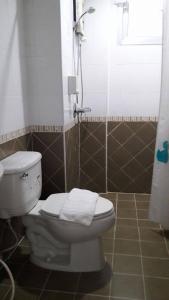 a bathroom with a toilet and a shower at Admire House in Pattaya Central