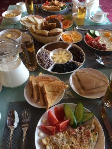 a table with plates of food on it at City Line Boutique Hotel in Tashkent