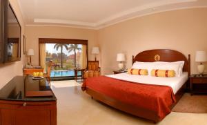 A bed or beds in a room at The Lalit Temple View
